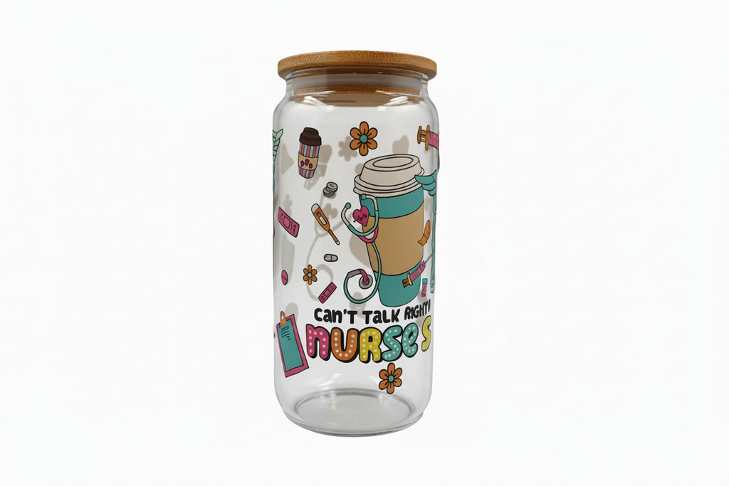 Clear glass tumbler with colorful design and text on a white surface