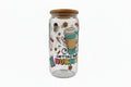 Clear glass tumbler with colorful design and text on a white surface